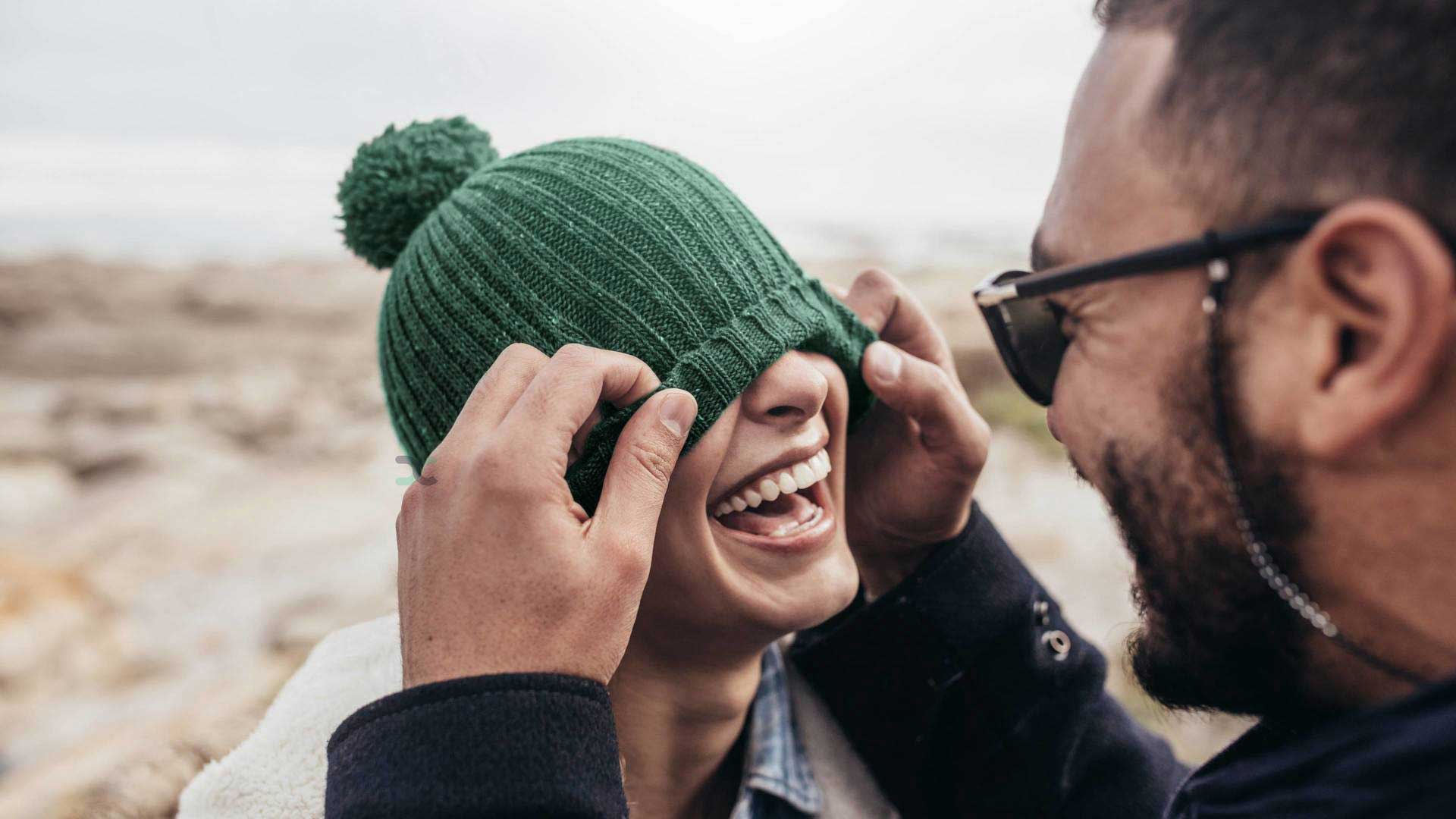 couple laughing with beanie