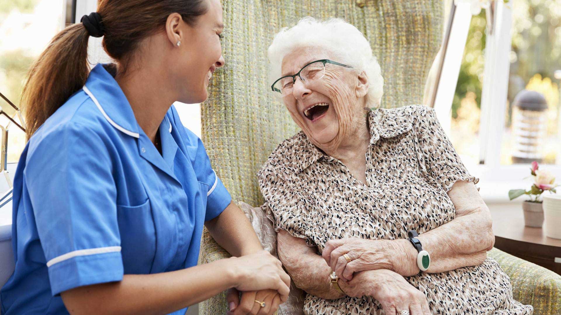 elderly lady laughing with nurse