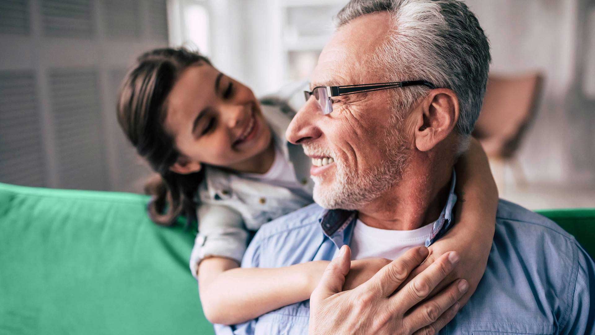 elderly man with smiling grandchild