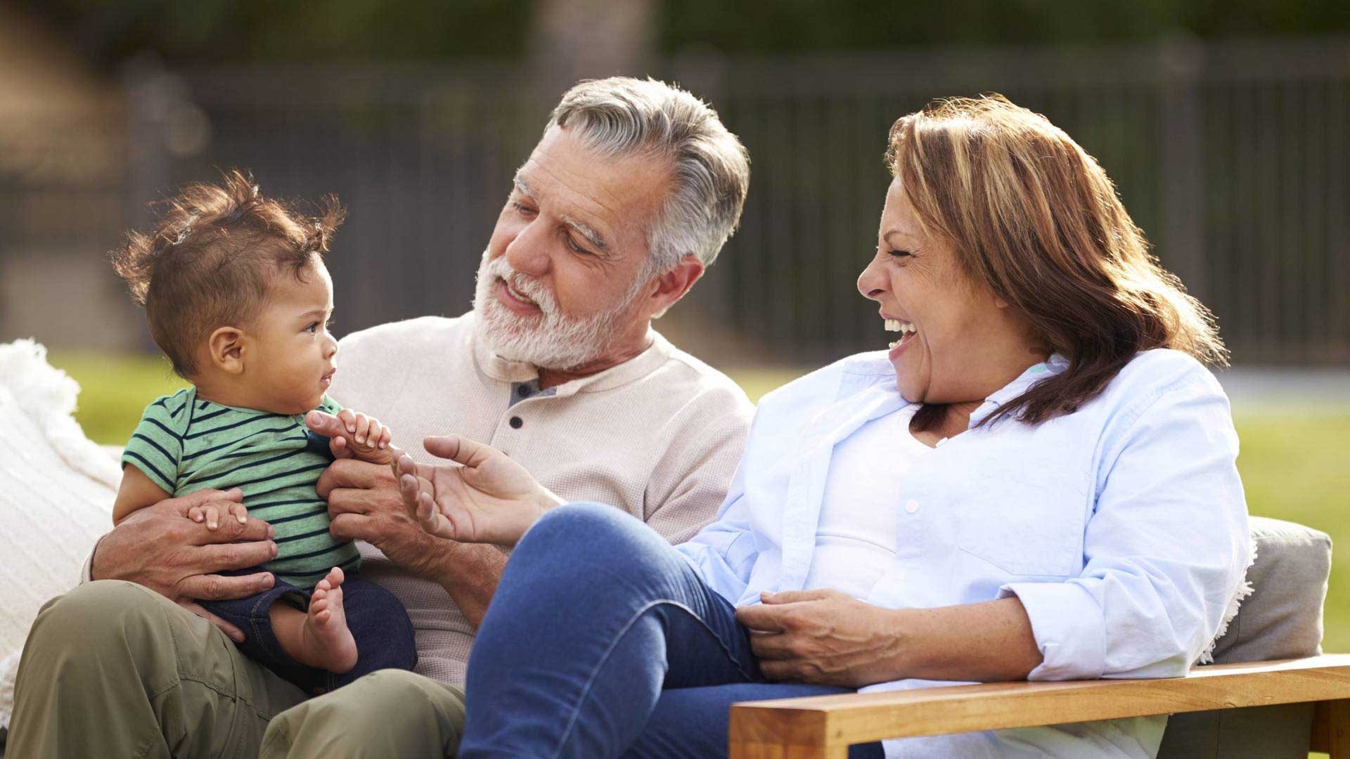 grandparents holding child
